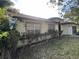 Single story home with well maintained landscaping and a mix of shade trees and flowering bushes at 10 Hickory Loop, Ocala, FL 34472