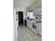 Functional kitchen with white appliances, tile floors, and ample cabinet space at 10 Hickory Loop, Ocala, FL 34472