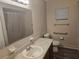 Bright bathroom with marble-look counter, white fixtures, safety bars, and neutral wall color at 10040 Sw 98Th Ave, Ocala, FL 34481