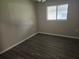Well-lit bedroom with a large window, neutral walls, and modern flooring, creating a serene space at 10040 Sw 98Th Ave, Ocala, FL 34481