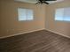 Cozy bedroom featuring two windows, a ceiling fan, and modern flooring for comfort at 10040 Sw 98Th Ave, Ocala, FL 34481