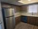 Modern kitchen featuring stainless steel refrigerator and dark wood cabinetry at 10040 Sw 98Th Ave, Ocala, FL 34481