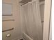 Shower with white tiled walls, a safety bar, and a white shower curtain at 10040 Sw 98Th Ave, Ocala, FL 34481