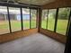 Relaxing sun room with wood-paneled walls and large windows overlooking the backyard at 10040 Sw 98Th Ave, Ocala, FL 34481