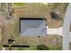 Aerial view of the home showcasing the roof, driveway, and surrounding expansive lawn with a playground at 10400 Sw 50Th Ct, Ocala, FL 34476