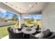 Covered back porch with outdoor seating perfect for enjoying the view of the backyard at 10400 Sw 50Th Ct, Ocala, FL 34476