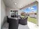 Relaxing covered back porch features comfortable seating and a view of the well-manicured backyard at 10400 Sw 50Th Ct, Ocala, FL 34476