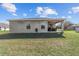 Exterior of home boasts well-maintained lawn and covered patio area for outdoor living and entertaining at 10400 Sw 50Th Ct, Ocala, FL 34476