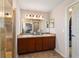 Bathroom with a dual sink vanity and a glass enclosed shower featuring tiled walls at 10400 Sw 50Th Ct, Ocala, FL 34476