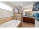 Bathroom featuring a soaking tub, separate shower, and double vanity sinks at 10400 Sw 50Th Ct, Ocala, FL 34476