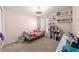 Pink bedroom with a brass bed, bright decor, and a ceiling fan at 10400 Sw 50Th Ct, Ocala, FL 34476