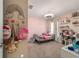 Pink bedroom with a brass bed, bright decor, and a ceiling fan at 10400 Sw 50Th Ct, Ocala, FL 34476