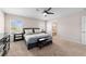 Primary bedroom with neutral walls and carpet, a ceiling fan, and two windows at 10400 Sw 50Th Ct, Ocala, FL 34476