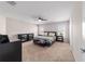 A primary bedroom offers neutral walls and carpet, a ceiling fan, and two windows at 10400 Sw 50Th Ct, Ocala, FL 34476