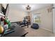 Comfortable bedroom boasts a unique ceiling fan and a view of the outdoors through the window at 10400 Sw 50Th Ct, Ocala, FL 34476