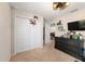 Bright bedroom boasts closet doors and a black dresser for storage at 10400 Sw 50Th Ct, Ocala, FL 34476