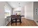 Dining area with chandelier, wood floors, and natural light from the windows at 10400 Sw 50Th Ct, Ocala, FL 34476
