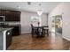 Bright dining area features wood floors, a modern chandelier, and sliding glass doors to the backyard at 10400 Sw 50Th Ct, Ocala, FL 34476
