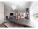 Open-concept dining and living space with ample natural light, chandelier, and view of modern furnishings at 10400 Sw 50Th Ct, Ocala, FL 34476