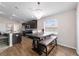 Open floor plan with a dining area featuring a chandelier, with views into the kitchen and wood flooring at 10400 Sw 50Th Ct, Ocala, FL 34476
