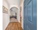 Open entryway with hardwood floors and a view into the living room at 10400 Sw 50Th Ct, Ocala, FL 34476