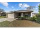 Well-maintained single-story home with an attached garage and neat landscaping at 10400 Sw 50Th Ct, Ocala, FL 34476