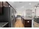 Open kitchen with stainless appliances, granite countertops, wood floors, and views throughout the home at 10400 Sw 50Th Ct, Ocala, FL 34476