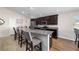 Open kitchen with bar seating, granite countertops, modern appliances, and plenty of cabinet space at 10400 Sw 50Th Ct, Ocala, FL 34476