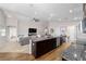 Open kitchen with granite countertops, stainless appliances, a ceiling fan, and views into the living room at 10400 Sw 50Th Ct, Ocala, FL 34476