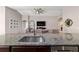 Open kitchen with granite countertops, a stainless sink, and views into the living room at 10400 Sw 50Th Ct, Ocala, FL 34476