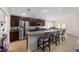 A kitchen features granite countertops, stainless steel appliances, and dark wood cabinets at 10400 Sw 50Th Ct, Ocala, FL 34476