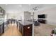 Open concept kitchen and living room with hardwood floors and granite countertops at 10400 Sw 50Th Ct, Ocala, FL 34476
