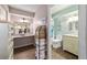 Bathroom with vanity, walk-in shower, and a view into a dressing area at 11475 Sw 85Th Ave, Ocala, FL 34481