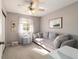 Cozy bedroom with a sleeper sofa, window and side table with decor plus a ceiling fan for extra comfort at 11475 Sw 85Th Ave, Ocala, FL 34481