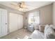 Bright bedroom featuring a sleeper sofa, window, ceiling fan and closet for comfortable modern living at 11475 Sw 85Th Ave, Ocala, FL 34481