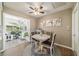Charming dining area with a marble-top table, elegant chairs, and a sunroom view, offering a bright and inviting space at 11475 Sw 85Th Ave, Ocala, FL 34481