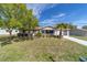 Charming home featuring well-manicured lawn, landscaping and a porch at 11475 Sw 85Th Ave, Ocala, FL 34481