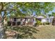 Charming home featuring a landscaped front yard with vibrant plants and mature trees, giving it great curb appeal at 11475 Sw 85Th Ave, Ocala, FL 34481