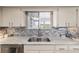 Close-up of kitchen sink with granite countertops and modern backsplash at 11475 Sw 85Th Ave, Ocala, FL 34481