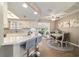 Modern kitchen featuring granite countertops, bar seating, and an open layout flowing into the dining area and sunroom at 11475 Sw 85Th Ave, Ocala, FL 34481
