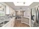 Kitchen features stainless steel appliances, marble countertops, and a view to the dining area at 11475 Sw 85Th Ave, Ocala, FL 34481