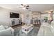 Comfortable living room with open kitchen, modern decor, and a large TV, perfect for entertaining and relaxing at 11475 Sw 85Th Ave, Ocala, FL 34481