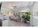 Bright sunroom with a ceiling fan, multiple windows, and comfortable seating at 11475 Sw 85Th Ave, Ocala, FL 34481