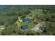 Aerial view of home with a pool, a spacious yard, and a separate garage at 11707 Se 101St Court Rd, Belleview, FL 34420