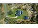 Gorgeous aerial shot showcasing the home's layout, the pool area, and the detached garage and vast surroundings at 11707 Se 101St Court Rd, Belleview, FL 34420