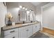Bathroom with granite counters, dual sinks and black hardware at 11707 Se 101St Court Rd, Belleview, FL 34420
