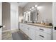 Bathroom with granite counters, dual sinks and black hardware at 11707 Se 101St Court Rd, Belleview, FL 34420