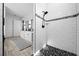 Modern bathroom featuring dual sinks, black hardware, a glass-enclosed shower and modern tile at 11707 Se 101St Court Rd, Belleview, FL 34420