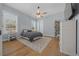 Bright bedroom with hardwood floors, ceiling fan, and two windows at 11707 Se 101St Court Rd, Belleview, FL 34420