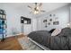 Comfortable bedroom with hardwood floors, ceiling fan, and decor at 11707 Se 101St Court Rd, Belleview, FL 34420